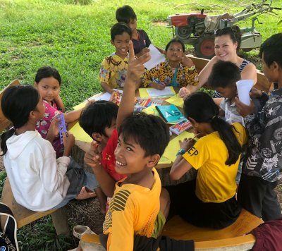 A man cycling through the rice fields in Cambodia.