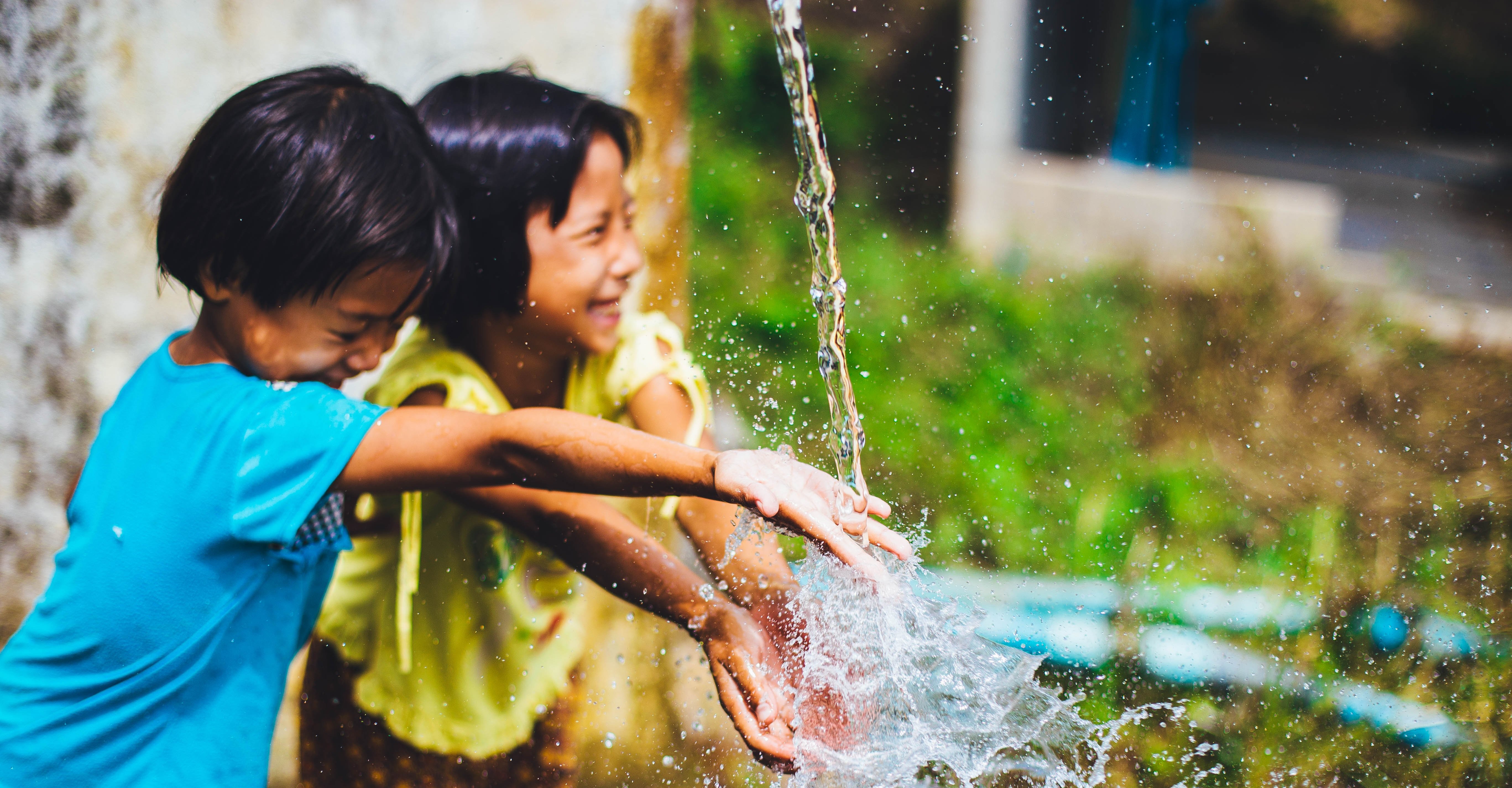 Children playing in water in Cambodia