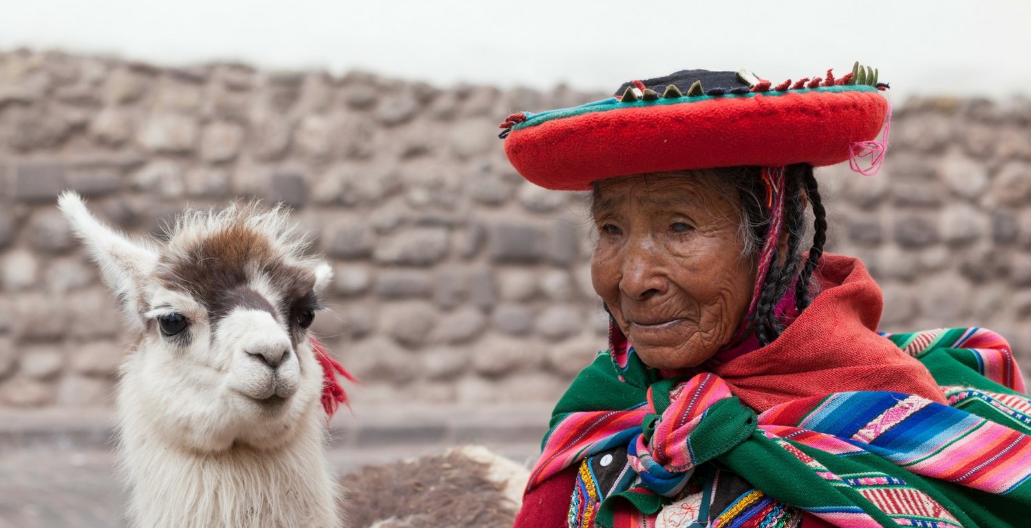 Pervian lady with a lama in Peru